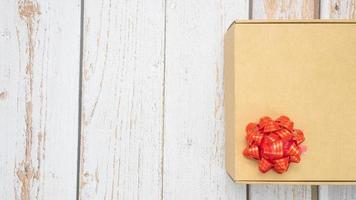 Gift box red ribbon on old wood top view copy space photo