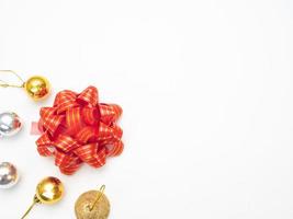 Christmas objects gold and silver with red ribbon top view copy space white background photo