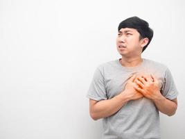 Man gesture hurt his chest looking at copy space photo
