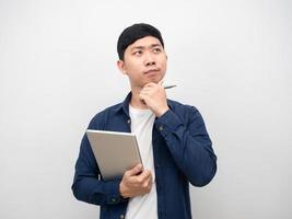 Handsome man holding tablet and pen gesture thinking about job photo