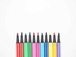 Close up color pen different array on white isolated top view copy space photo