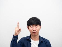 Man point finger at copy space feeling confused at his face portrait