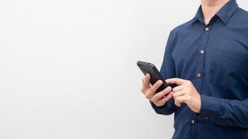Man using mobile phone in hand for shopping crop shot copy space white background photo