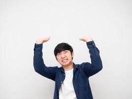 Asian man gesture carry something serious face,Asian man gesture carry product on his head white background photo