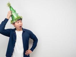 Man wearing green hat feeling amazed looking at copy space photo