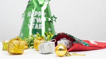 Close up christmas items with green hat happy new year concept on the table white background copy space photo