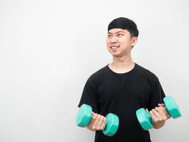 Man exercise with dumbbell feeling enjoy and looking at copy space photo