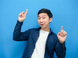 Cheerful man gesture funny dance blue background photo