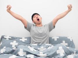 Asian man wake up at morning yawn and feeling sleepy photo