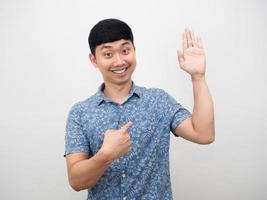 Man smiling hand up surrender and point finger at himself photo