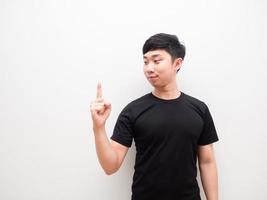 Asian man look at finger right hand up confident face on white isolated background space