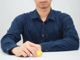 Man sitting at table with golden bitcoin in his hand photo