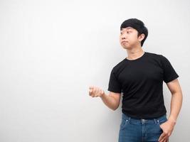 Asian man with jeans gesture pull hand at copy space photo