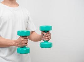 Man holding dumbbell green clolor white background crop shot copy space photo