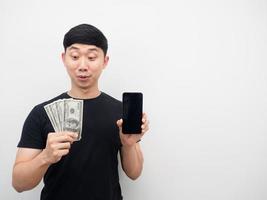 Man feeling excited looking money in hand copy space photo