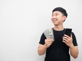 Man holding mobile phone and money smile looking at copy space photo