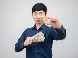 Asian man cheerful holding money dollar and gold bitcoin the digital money concept white background photo