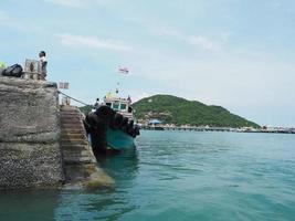 Boat port at the island in thailand with mountain view background blue sky ocean photo