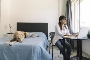 Busy and focused Latina woman working from home photo