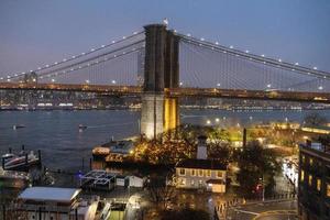 Brooklyn Bridge and view of Dumbo at night photo