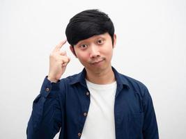 Young man point finger at his head gesture thinking portrait white background photo