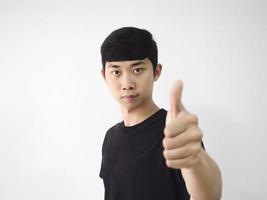 Young man black shirt left thumb up feel confident at face blur on white isolate background photo