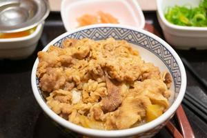 close up view to traditional japanese food fried beef slide on rice, gyudon photo