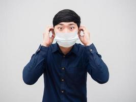 Closeup asian man wearing protect mask excited face white background photo