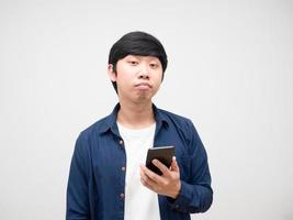 Young man holding cell phone feeling bored emotion portrait white isolated photo