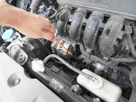 Car maintenance technician checking with car auto engine concept photo