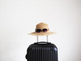 Vintage hat with sunglasses above luggage on white isolated holiday and travel concept space