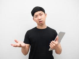 Man holding tablet feeling angry and serious photo