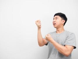 Young man grey shirt gesture pull empty rope on his head photo