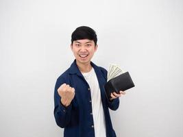 Rich asian man happy face show fist up and money in wallet on white isolated background photo