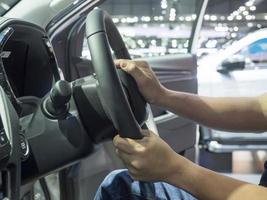 Man hand at steering wheel of car,Hand test drive at steering wheel concept new car photo