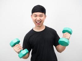 Man with dumbbell feeling joyful with exercise photo