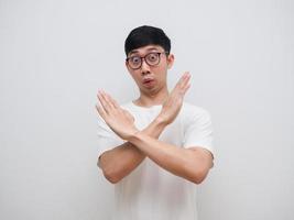 Glasses man say no and cross arms up white shirt look at camera on white isolated background photo