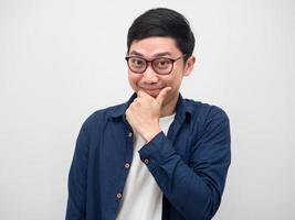 Asian man wearing glasses touch his face and smile looking at camera photo