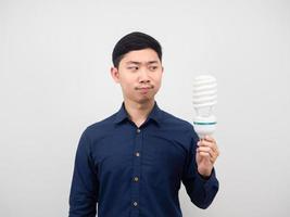 Man looking at light bulb led in hand white background photo