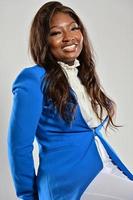 Beautiful happy young African American girl posing in studio, looking at camera. photo