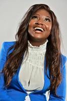 Beautiful happy young African American girl posing in studio, looking at camera. photo