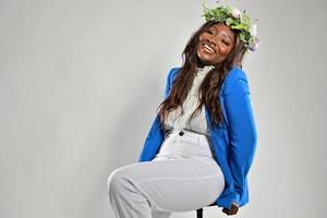 Portrait of a young African American female , model of fashion, with big flowers in her hair photo