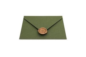 green envelope with designer cardboard and seal on a white background. Envelope with seal photo