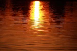 Sunset orange lake water reflection landscape. Sunset water reflection. River sunset orange view. photo
