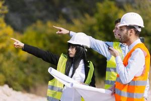 Surveyor engineer is measuring level on construction site. Surveyors ensure precise measurements before undertaking large construction projects. photo