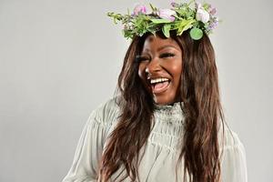 Portrait of a young African American female , model of fashion, with big flowers in her hair photo