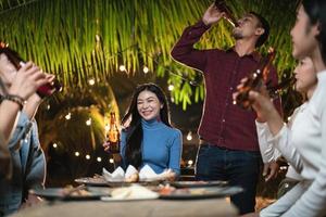 Young Asian people raising a toast at the party photo