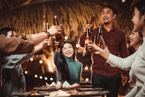 group of people celebrating outdoors in the garden by drinking beer photo