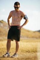 Athletic young man stretching after run in the nature. sport concept photo