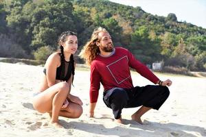 friends relaxing and talking on the beach photo